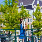 Young beautiful girl walking in european city, Amsterdam, Holland